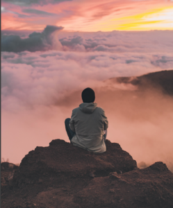 Man meditating on a cliff