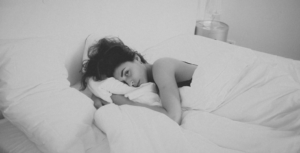 woman awake in bed with sleep paralysis